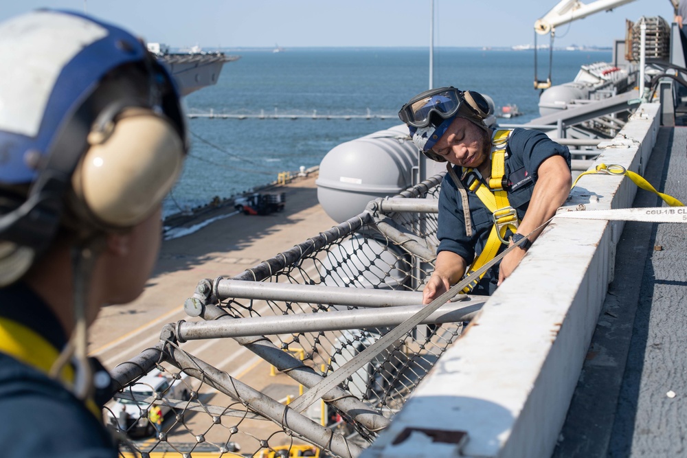 U.S. Sailors raise a net