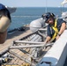 U.S. Sailors raise a net