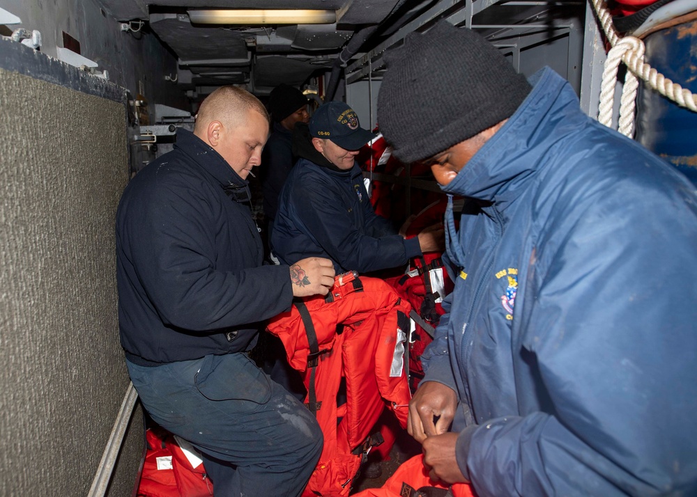 USS Normandy Sailors Conduct Maintenance Checks on Life Preservers