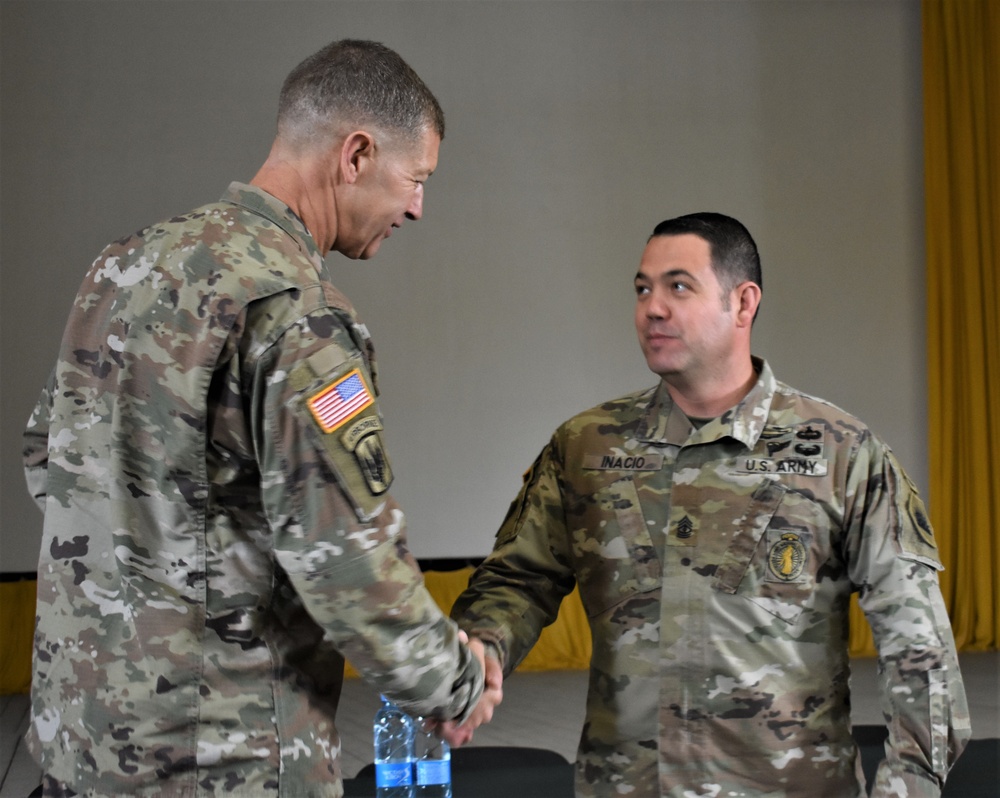 Maj. Gen. Jarrard awards soldiers with his service coin during RT19