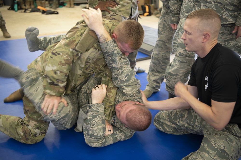 Godzilla Class officer Trainees spar during combatives class