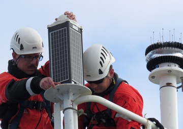 U.S. Coast Guard Petty Officers install Aids to Navigation Light