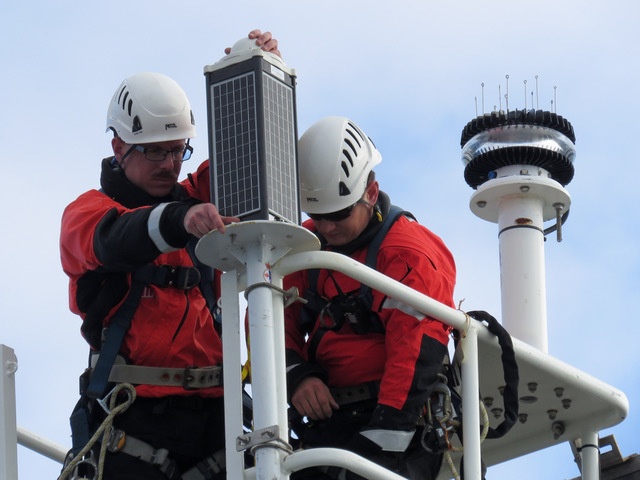 U.S. Coast Guard Petty Officers install Aids to Navigation Light