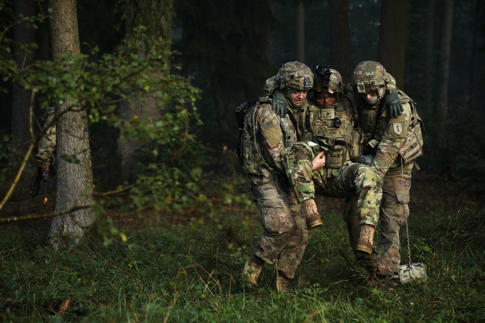 U.S. Soldiers carry a casualty after a simulated attack during Saber Junction 19