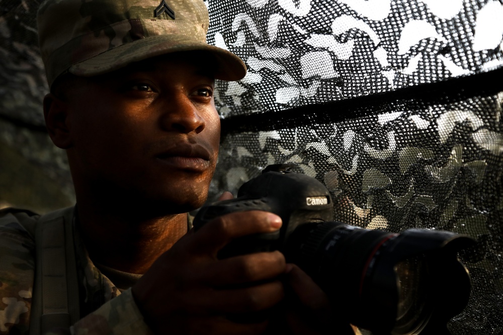 U.S. Army Cpl. Tomarius Roberts prepares to take a photo during Saber Junction 19