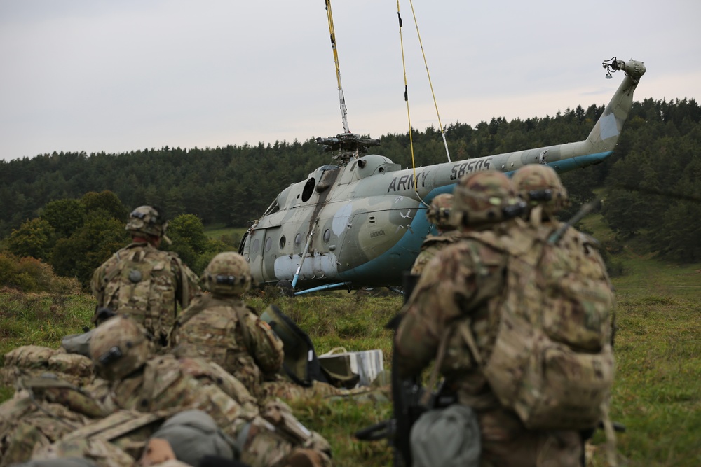 U.S. Soldiers wait for a vehicle airlift during Saber Junction 19