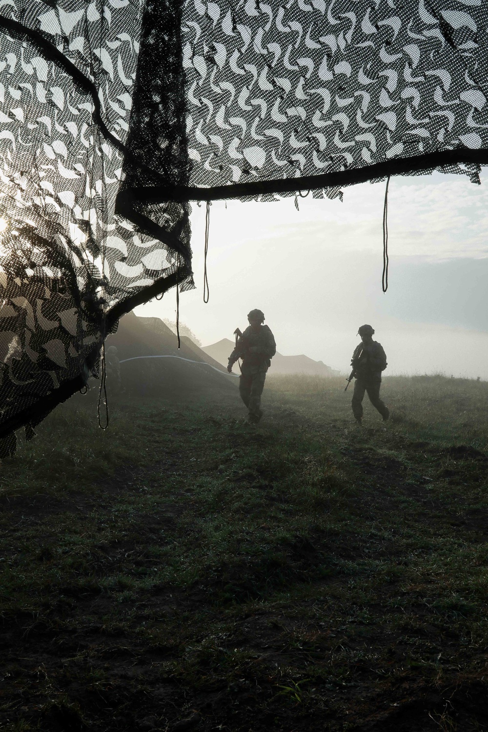 U.S. Soldiers patrol through their camp during Saber Junction 19
