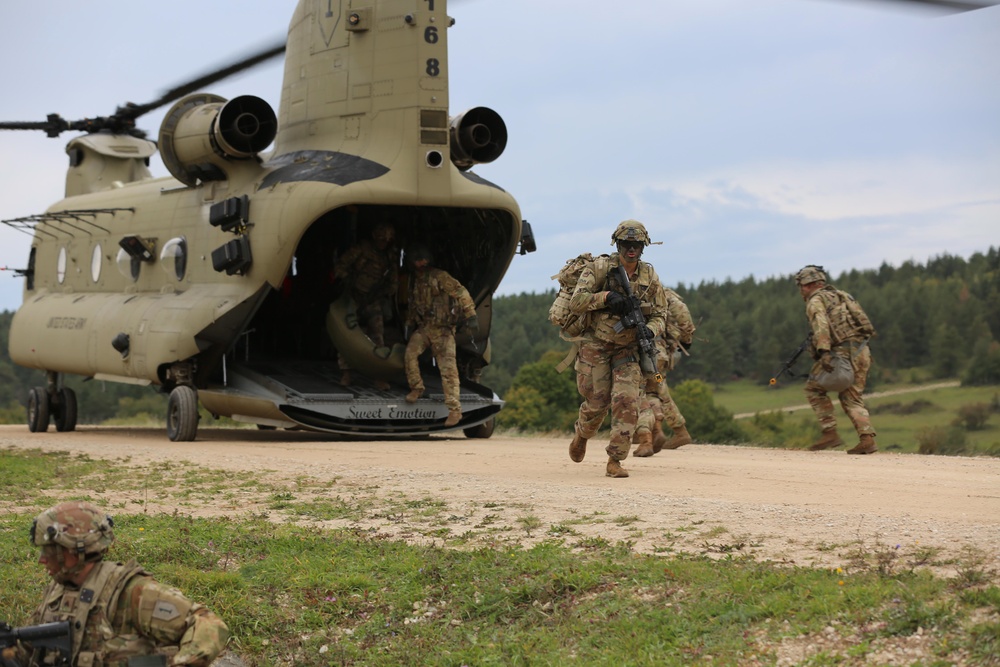 U.S. Soldiers dismount from a CH-47 Chinook helicopter during Saber Junction 19