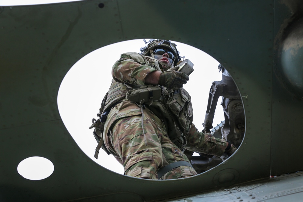 U.S. Soldiers dismount from a CH-47 Chinook helicopter during Saber Junction 19