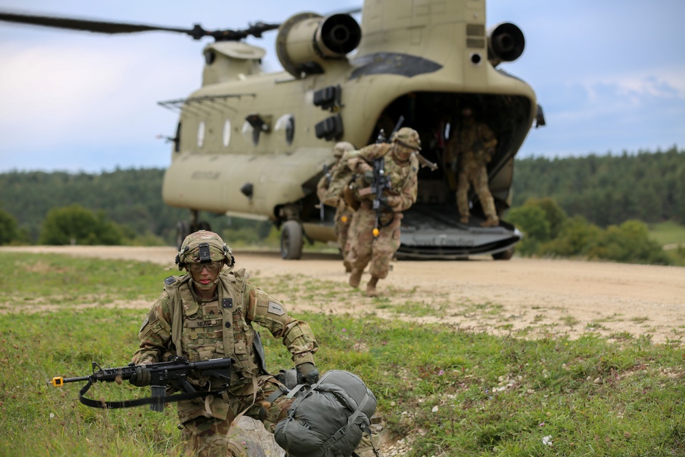 U.S. Soldiers dismount from CH-47 Chinook helicopter during  Saber Junction 19