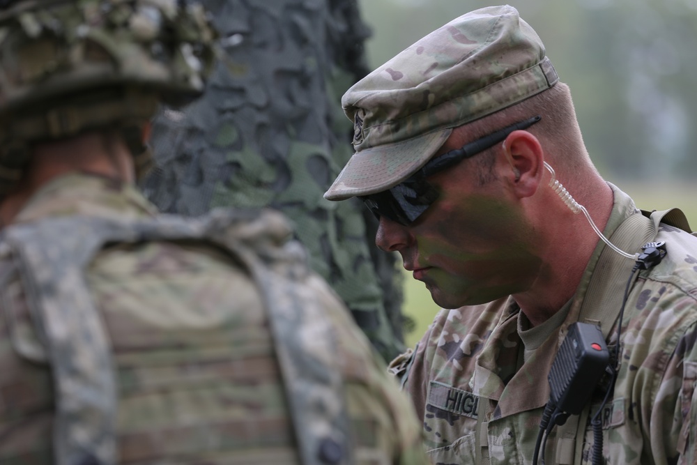 An Observer Coach Trainer interacts with a soldier during Saber Junction 19