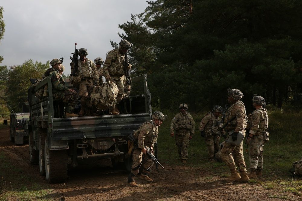 U.S. Soldiers dismount a Light Medium Tactical Vehicle during Saber Junction 19