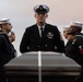 U.S. Navy Senior Chief Aviation Electronics Technichian James Hendricks, from Porum, Oklahoma, stands at parade rest during a burial at sea