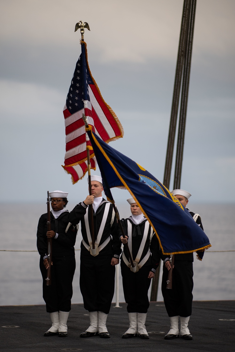 U.S. Sailors stand at attention during a burial at sea