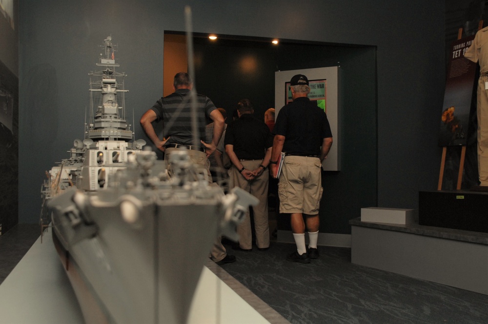 Museum volunteers tour upcoming exhibit at Naval Museum