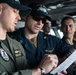 U.S. Sailors discuss turns for an inbound transit