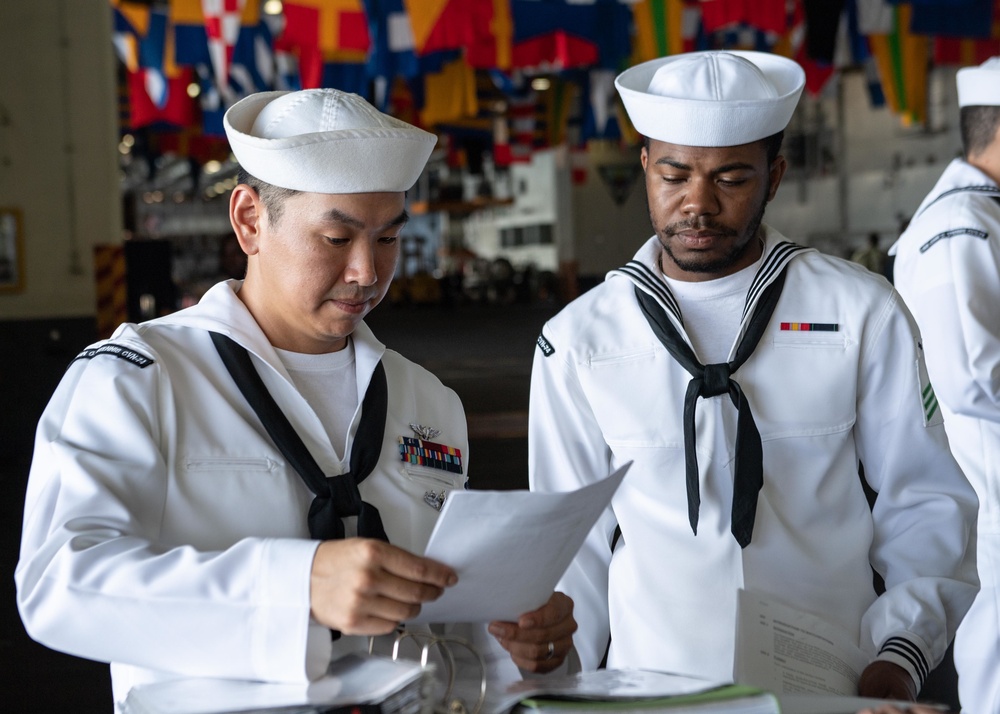 U.S. Sailors prepare to stand watch