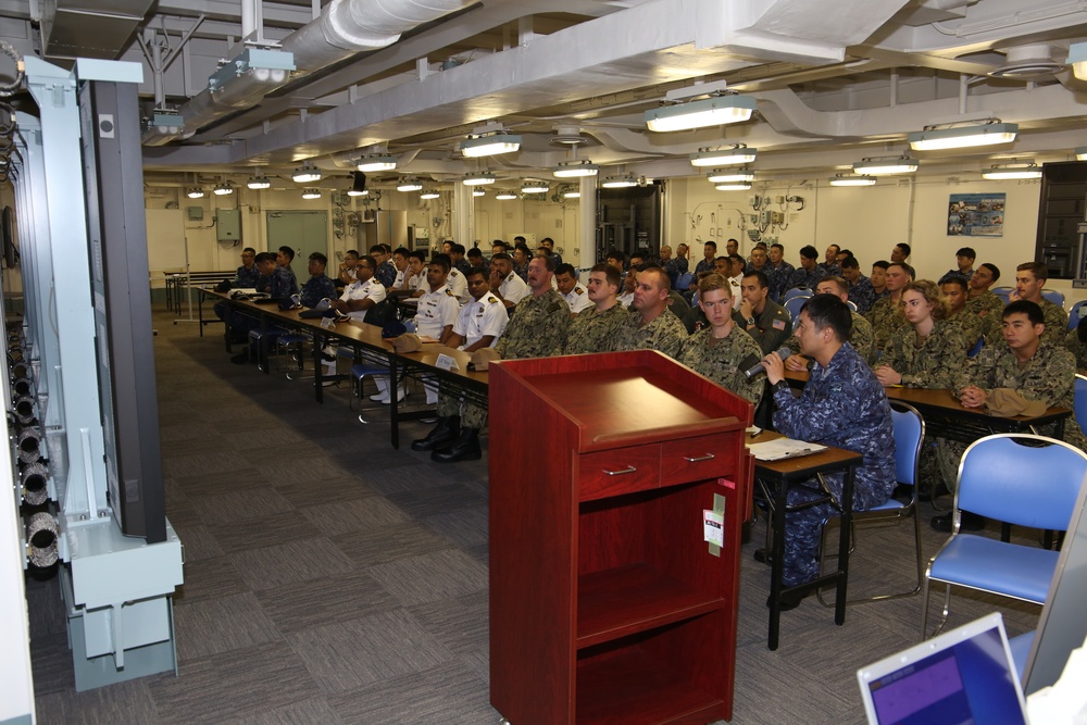 USS McCampbell Sailors board JS Kaga for a junior officer exchange during Malabar 2019