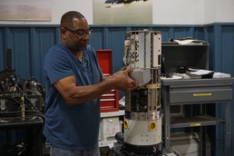 Dawine Thomas, LEMC Anti-Radiation Missile Technician, removes the battery from a High-Speed Anti-Radiation Missile at Letterkenny Munitions Center. The LEMC mobile maintenance team supports unit readiness within the U.S. and overseas.