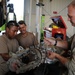 Ecuadorian Soldiers work on a transmission for a humvee