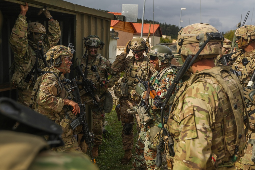 U.S. Soldiers and a North Macedonia soldier converse during Saber Junction 19