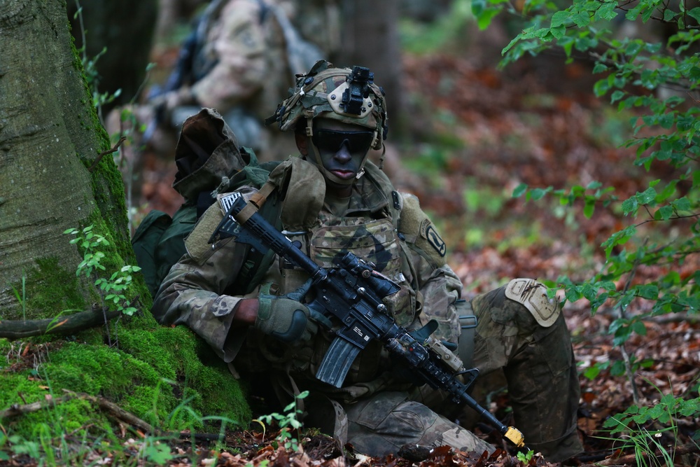A U.S. Soldier rests against a tree after a patrol during Saber Junction 19