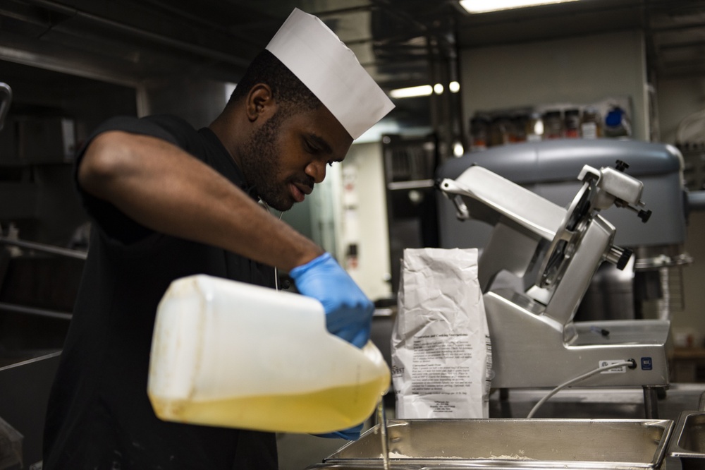 USS San Jacinto Sailor Prepares Dinner