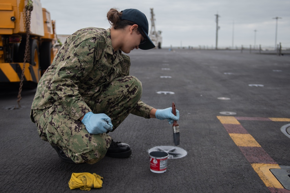 U.S. Sailor paints a padeye on the flight deck of the aircraft carrier John C. Stennis