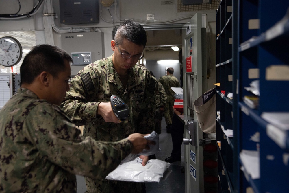 U.S. Sailors disperses mail in the post office