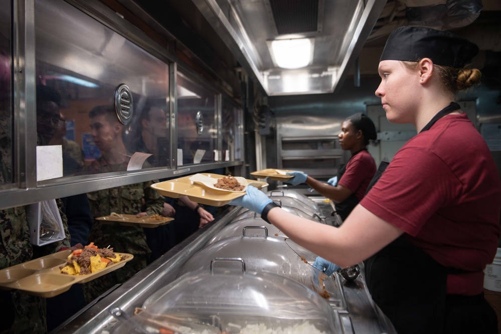 U.S. Sailor serves food