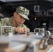 U.S. Sailor scrubs an ammunition storage box