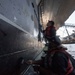 U.S. Sailors paint the ship
