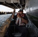 U.S. Sailor paddles a boat