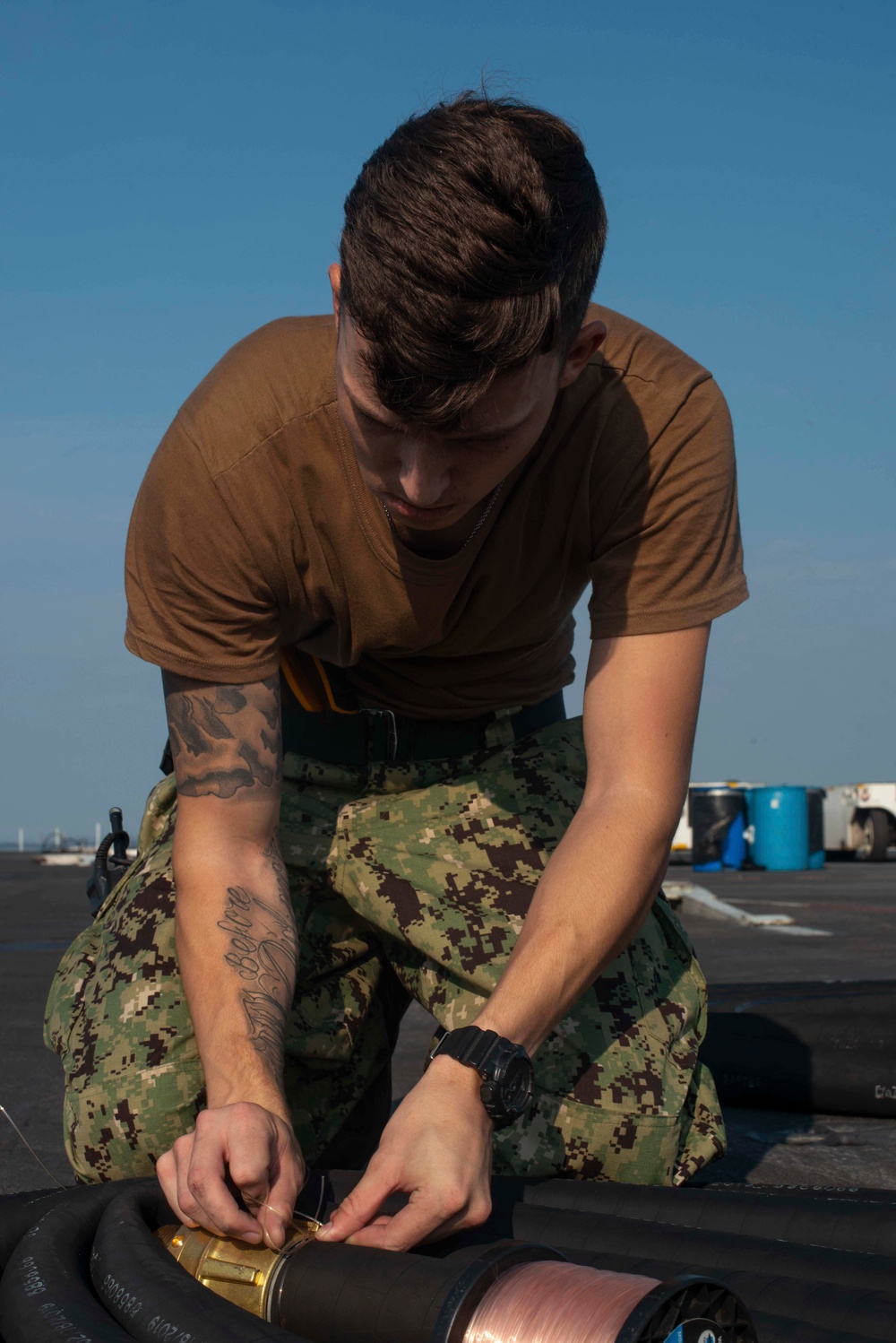 U.S. Sailor ties fuel line