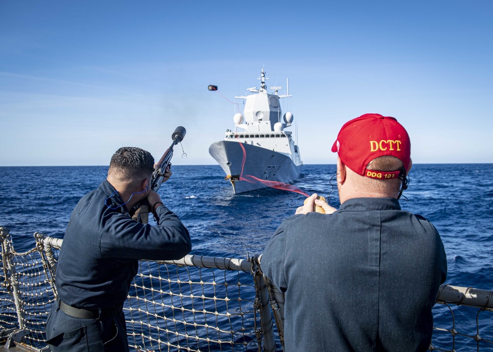 USS Gridley Sailors Fire a Shot Line to HNoMS Thor Heyerdahl