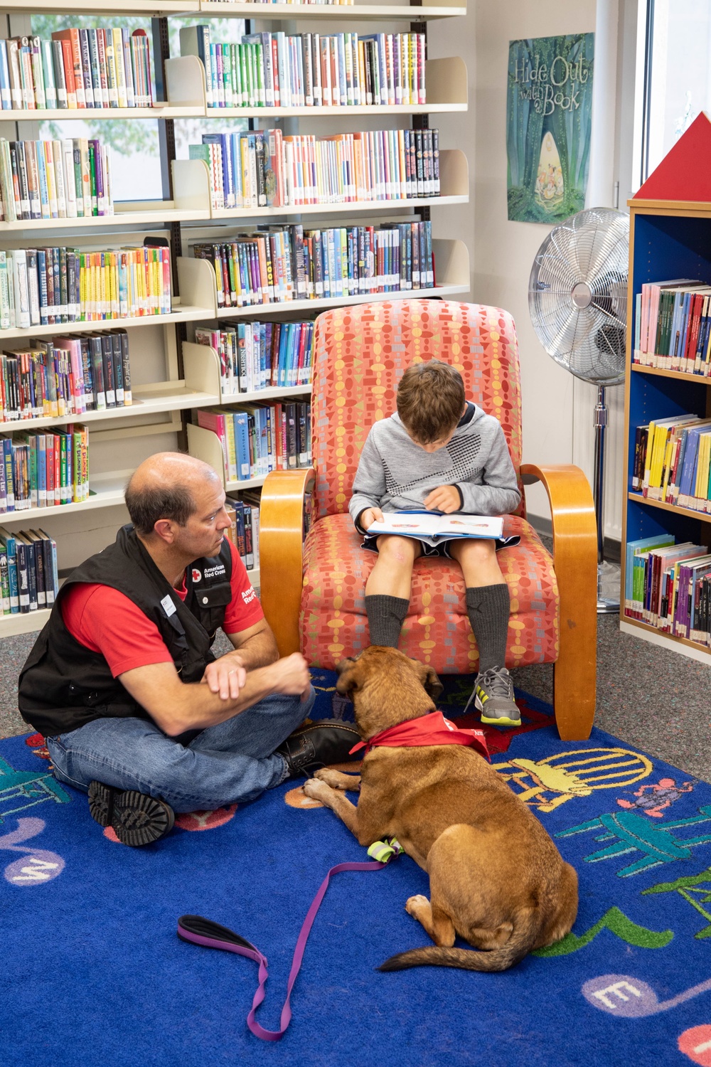 Dog visits Wiesbaden Library for PaWs read-aloud program