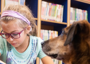 Dog visits Wiesbaden Library for PaWs read-aloud program