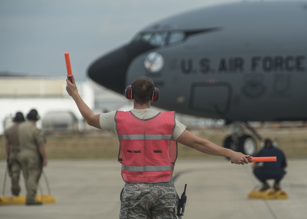 Airman marshals KC-135 on the 121ARW flight line