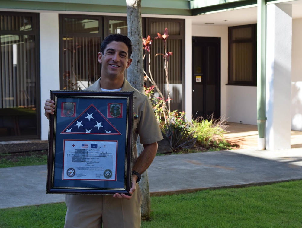 LT Yahalom holds framed flag and coin to present to NHCH