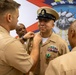 Chief Warrant Officer 2 Juan Castillo has his Senior Chief insignia removed by his fellow chiefs as part of his officer commissioning ceremony