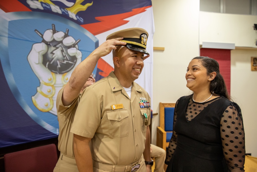 Chief Warrant Officer 2 Juan Castillo has his officer insignia placed on by his Chief Engineer and his wife