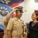 Chief Warrant Officer 2 Juan Castillo has his officer insignia placed on by his Chief Engineer and his wife