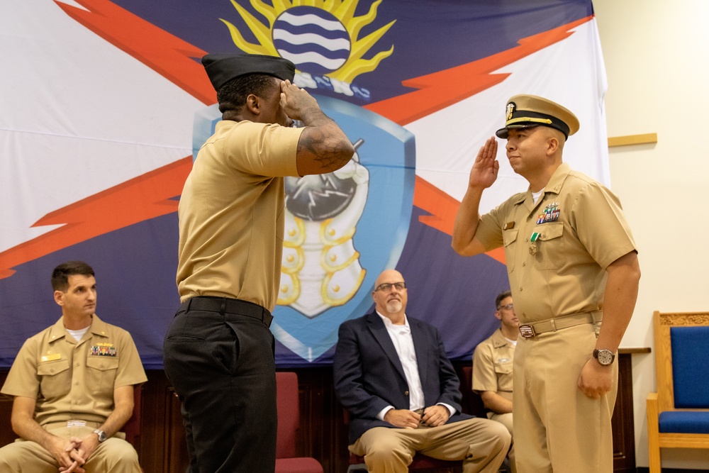 Chief Warrant Officer 2 Juan Castillo gives his first salute as an officer in the United States Navy