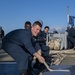 USS Normandy Sailors Heave Mooring Line