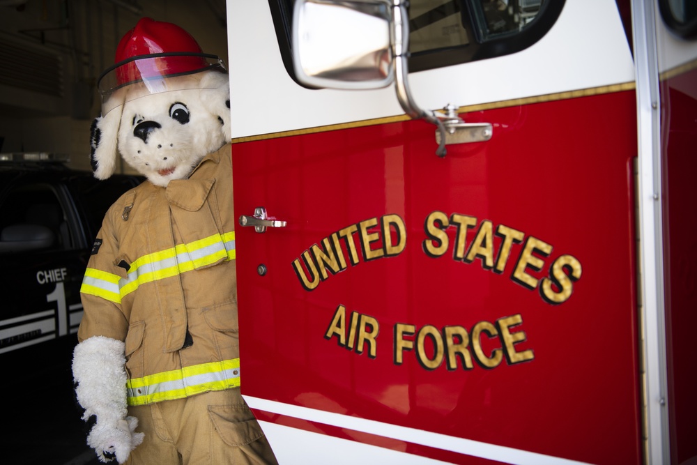 Sparky poses with fire truck.