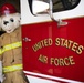 Sparky poses with fire truck.