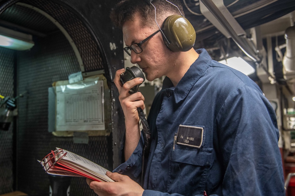 Sailors Work Aboard USS Harpers Ferry