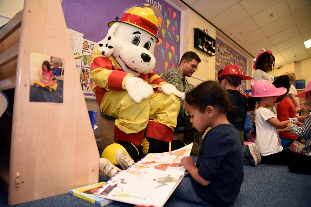 Reading with 100th Civil Engineer Squadron firefighters, Sparky the Fire Dog