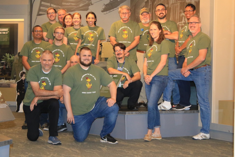 Museum staff members pose for a photo before new exhibit opens