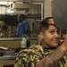 Retail Service Specialist Inspects Haircut